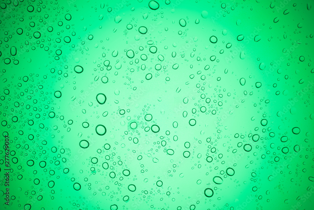 Rain droplets on green glass background, Water drops on glass. Rain droplets on green glass background, Water drops on glass.