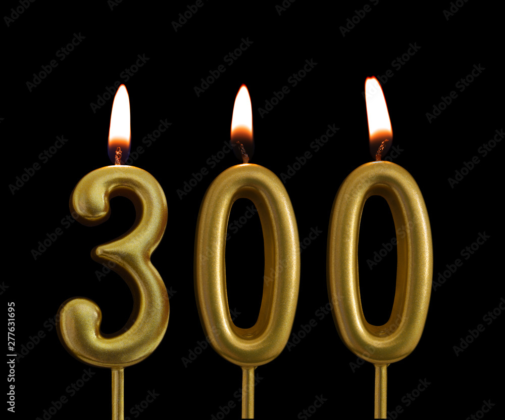 Golden birthday candles isolated on black background, number 300 Golden birthday candles isolated on black background, number 300
