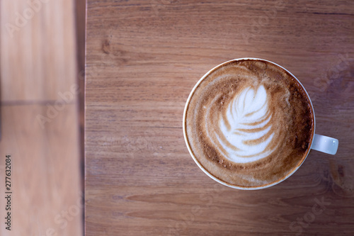 Cup of coffee latte on wood table.