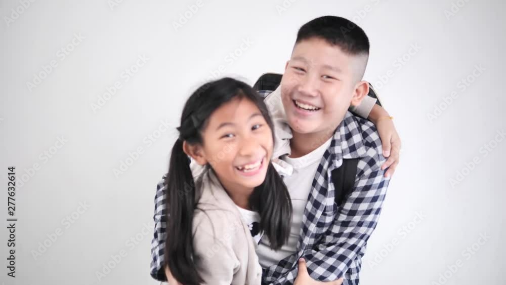 Happy Asian girl jumping to her brother for piggyback with fun together, lifestyle concept. Happy Asian girl jumping to her brother for piggyback with fun together, lifestyle concept.
