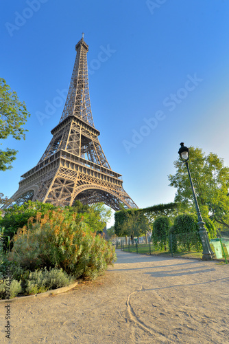 Eiffel tower in Paris view from a little path in garden of Champs de Mars © coco