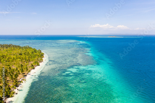 Large tropical island white sandy beach, view from above. Seascape, nature of the Philippine Islands. Tropical forest and sea lagoons.