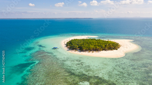 Patawan island. Small tropical island with white sandy beach. Beautiful island on the atoll, view from above. Nature of the Philippine Islands.