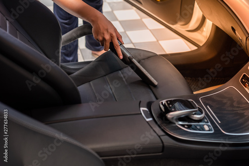 Cleaning of interior of the car with vacuum cleaner