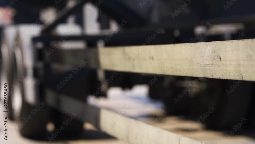 An extreme close up of long vehicle trallers tyre and bottom An extreme close up of long vehicle trallers tyre and bottom