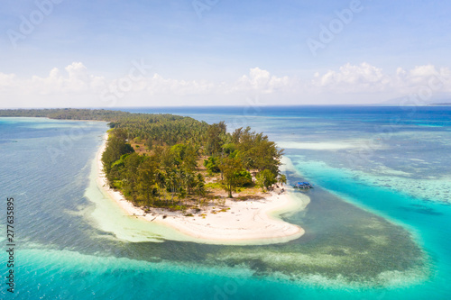 Canabungan Island with sandy beach. Tropical island with white beach on the large atoll, aerial view. Seascape, Philippine Islands.