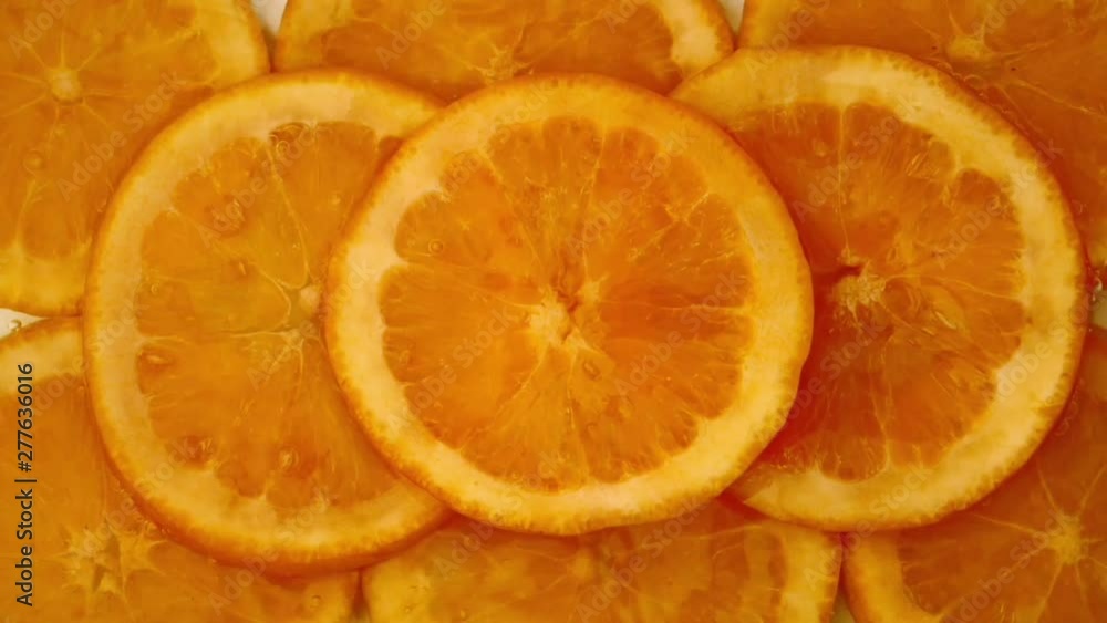 Water pouring on sliced orange fruit background Water pouring on sliced orange fruit background