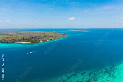 Large islands located on the atolls, a top view. Island with forest.