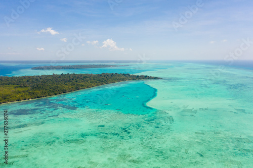 Fototapeta Naklejka Na Ścianę i Meble -  Coral reefs and atolls in the tropical sea, top view. Turquoise sea water and beautiful shallows. Philippine nature.