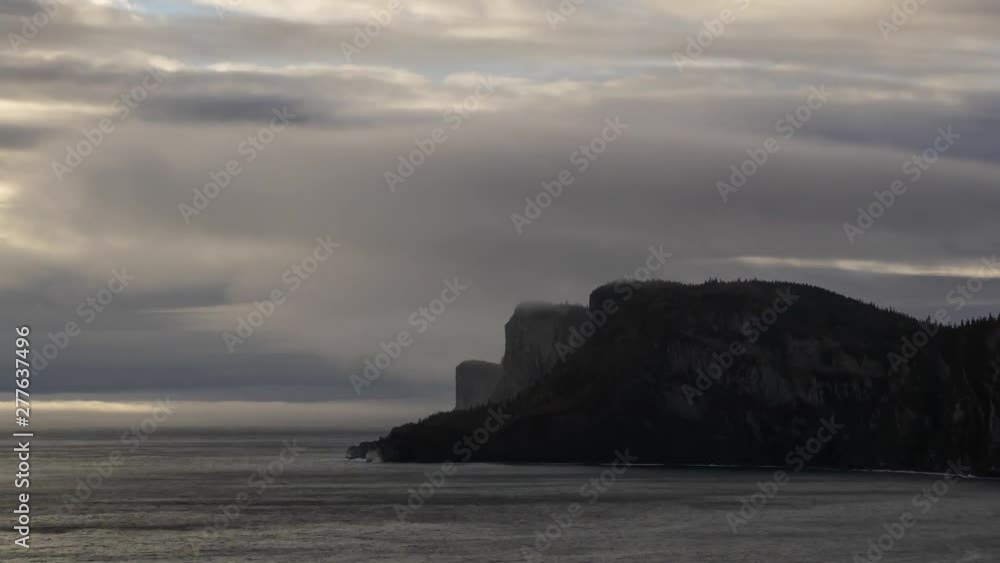 Timelapse of a Striking landscape of a rocky coastline during a cloudy sunrise. Taken in Forillon National Park, near Gaspe, Quebec, Canada. Timelapse of a Striking landscape of a rocky coastline during a cloudy sunrise. Taken in Forillon National Park, near Gaspe, Quebec, Canada.