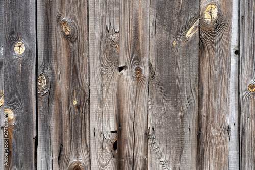 old peeling wooden boards. Background natural wooden boards. Texture of old unpainted wooden planks. Vertical arrangement of shabby wooden boards.