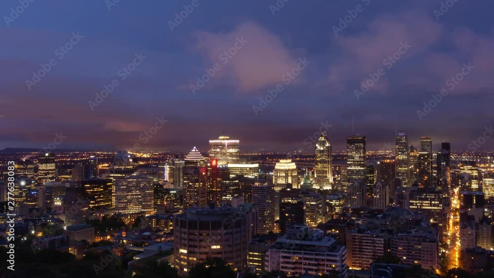 Aerial Time Lapse of a beautiful modern downtown city during a striking cloudy sunrise. Taken in Mt Royal, Montreal, Quebec, Canada. Aerial Time Lapse of a beautiful modern downtown city during a striking cloudy sunrise. Taken in Mt Royal, Montreal, Quebec, Canada.