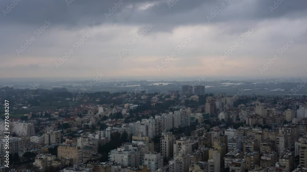 Aerial Time Lapse of a residential neighborhood in a city during a stormy cloudy sunrise. Taken in Netanya, Center District, Israel. Aerial Time Lapse of a residential neighborhood in a city during a stormy cloudy sunrise. Taken in Netanya, Center District, Israel.