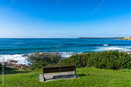 Ocean landscape with one bench on a cliff
