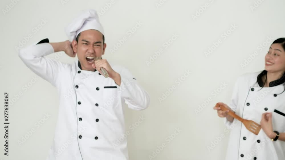 Happy Asian chefs dancing together, slow motion. Happy Asian chefs dancing together, slow motion.