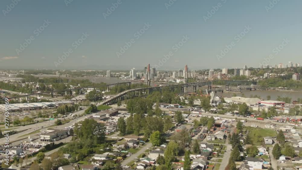 Aerial view of Pattullo and the Skytrain Bridge going over Fraser River from Surrey to New Westminster during a sunny day. Taken in Greater Vancouver, British Columbia, Canada. Aerial view of Pattullo and the Skytrain Bridge going over Fraser River from Surrey to New Westminster during a sunny day. Taken in Greater Vancouver, British Columbia, Canada.