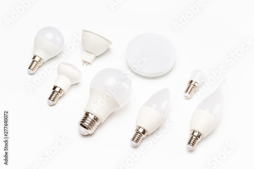 Group of different energy saving lamps isolated at yellow background.