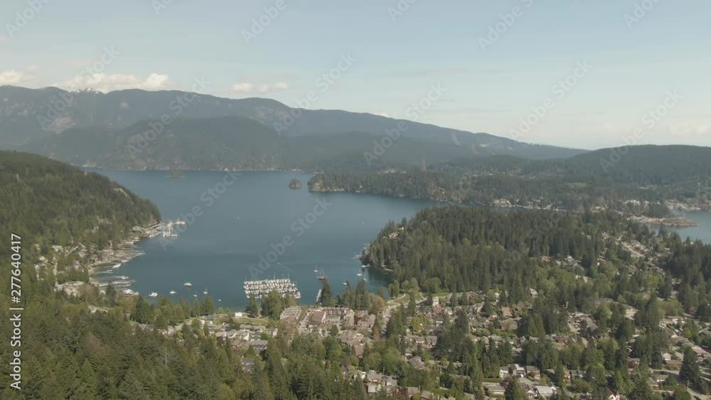Aerial view of Residential homes in Deep Cove during a vibrant sunny day. Taken in North Vancouver, British Columbia, Canada. Aerial view of Residential homes in Deep Cove during a vibrant sunny day. Taken in North Vancouver, British Columbia, Canada.