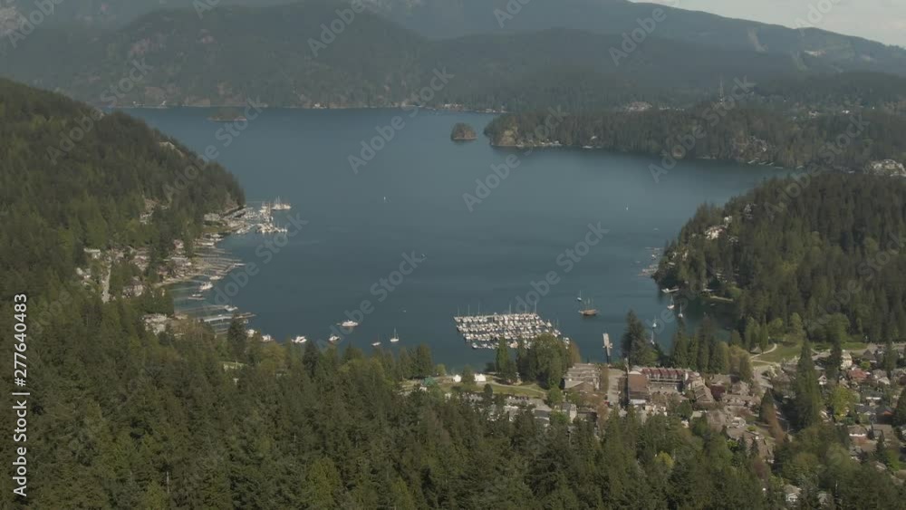 Aerial view of Residential homes in Deep Cove during a vibrant sunny day. Taken in North Vancouver, British Columbia, Canada. Aerial view of Residential homes in Deep Cove during a vibrant sunny day. Taken in North Vancouver, British Columbia, Canada.