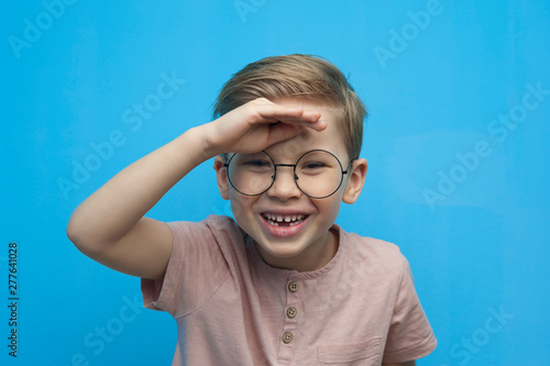 Portrait of a laughing little boy with glasses