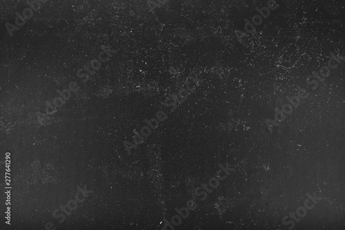 White dust and scratches over black surface. Distressed effect background. Empty space.