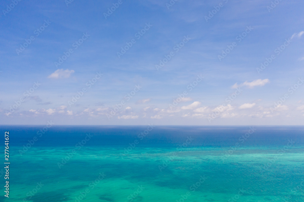 Obraz premium Coral reefs and atolls in the tropical sea, top view. Turquoise sea water and beautiful shallows. Philippine nature.