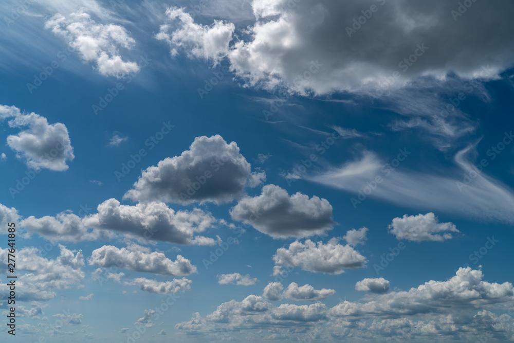 white clouds float in the blue sky white clouds float in the blue sky