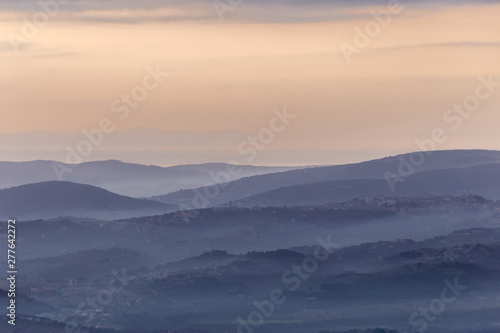 A view of Perugia city (Umbria, Italy) in the middle of hills and mist at dusk © Massimo