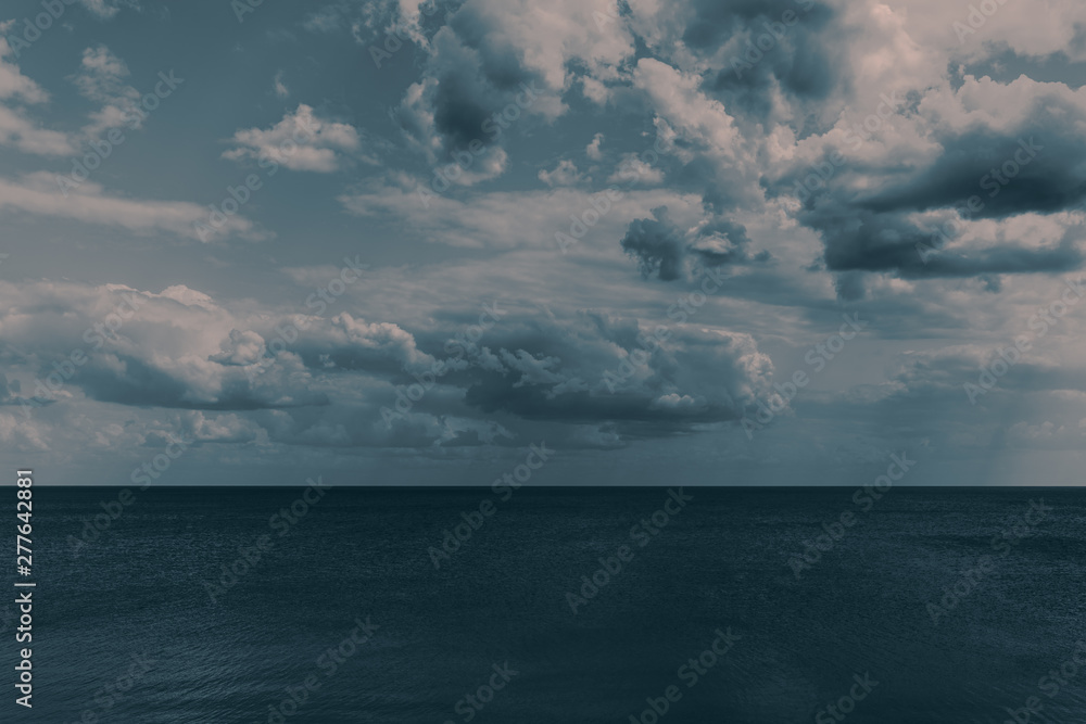white clouds float in the sky above the sea white clouds float in the sky above the sea