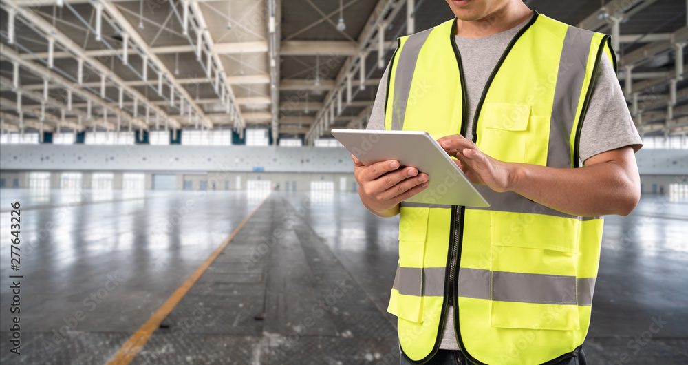 worker hand holding pad for check order pick time in empty warehouse worker hand holding pad for check order pick time in empty warehouse