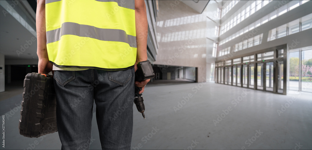 Construction Worker in front of construction site Construction Worker in front of construction site