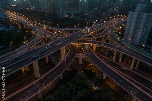 aerial view of buildings and highway interchange at dawn in Shanghai city