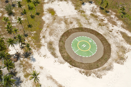 Helipad on a tropical island. Balabac, Palawan, Philippines. Helipad among the palm trees on a tropical island, top view.