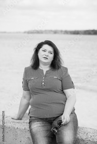 Sad Simple plump middle aged woman thinking about something, crisis of middle age and problems among overweight people  © T.Den_Team