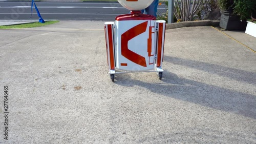 white and red oval head robot moves to right frame and spins head close up. Filmed at Australia, Queensland, Sunshine Coast, Maroochydore in 4K. photo