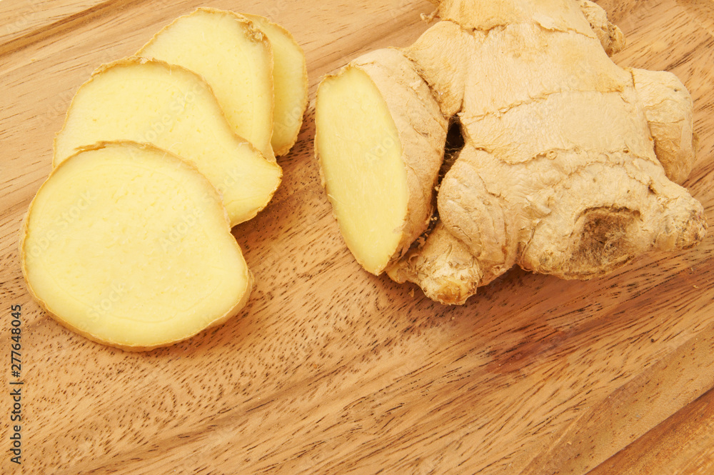 Raw ginger root on wooden background