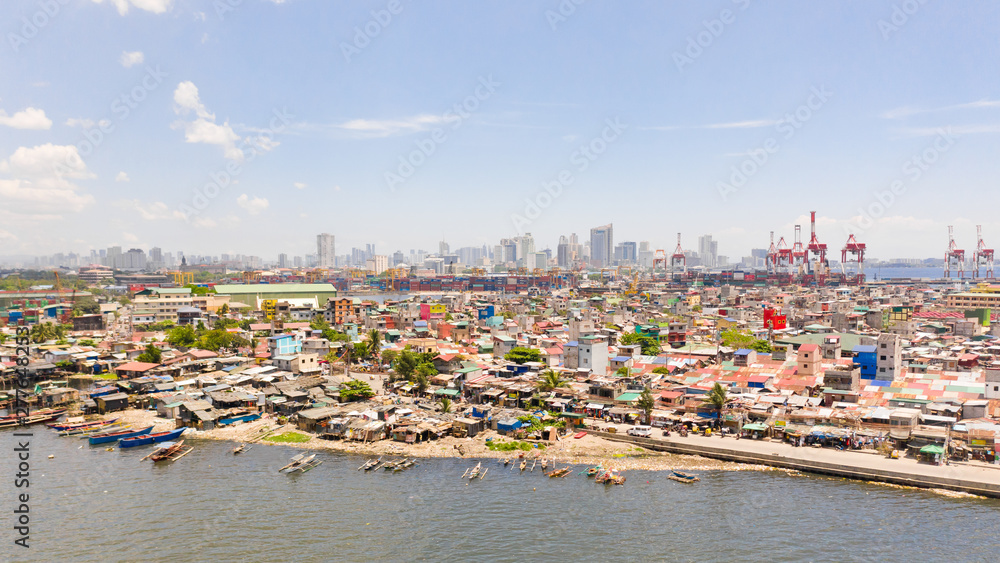 The urban landscape of Manila, with slums and skyscrapers. Sea port and residential areas. The contrast of poor and rich areas. The capital of the Philippines, view from above.