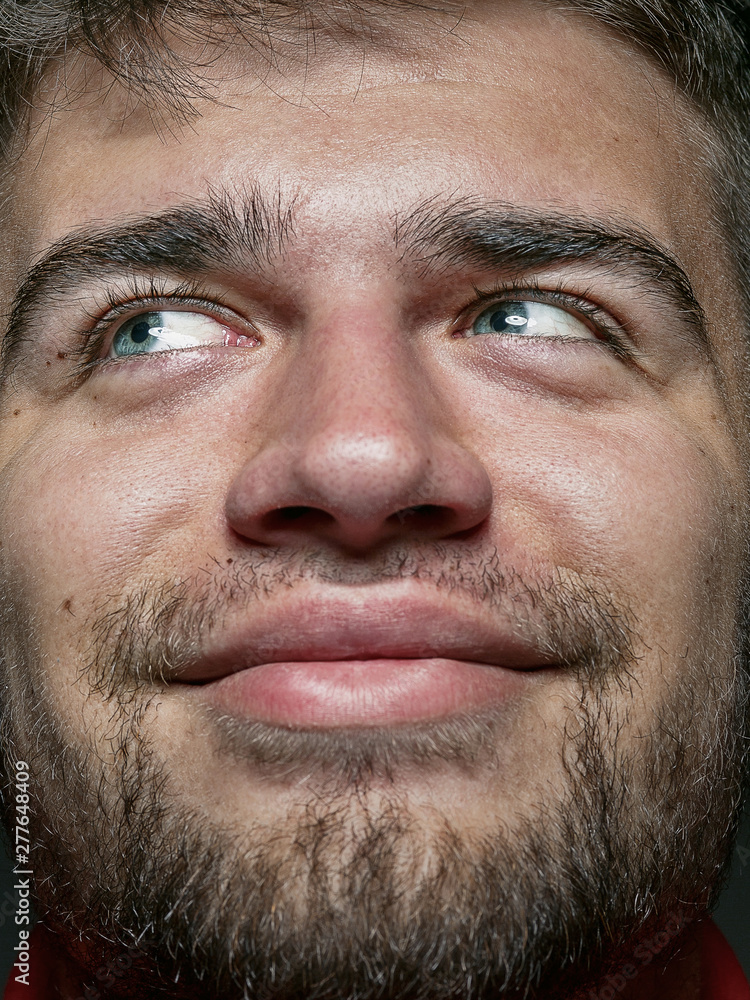 Fototapeta premium Close up portrait of young and emotional caucasian man. Highly detail photoshot of male model with well-kept skin and bright facial expression. Concept of human emotions. Smiling and looks happy.