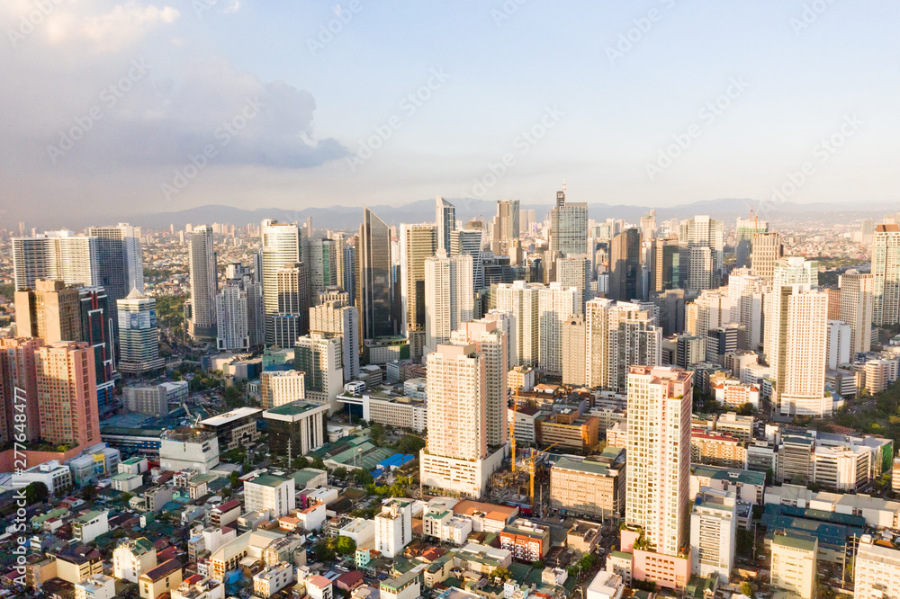 Naklejka premium Modern city. The city of Manila, the capital of the Philippines. Modern metropolis in the morning, top view. Modern buildings in the city center.