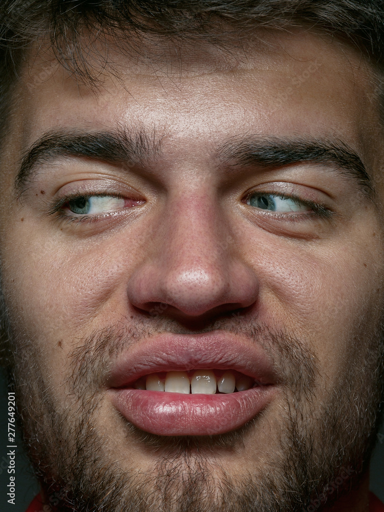 Close up portrait of young and emotional caucasian man. Highly detail photoshot of male model with well-kept skin and bright facial expression. Concept of human emotions. Disgusting feeling. Close up portrait of young and emotional caucasian man. Highly detail photoshot of male model with well-kept skin and bright facial expression. Concept of human emotions. Disgusting feeling.
