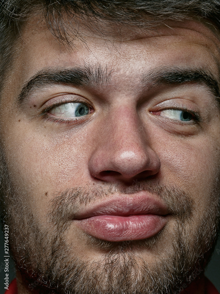 Close up portrait of young and emotional caucasian man. Highly detail photoshot of male model with well-kept skin and bright facial expression. Concept of human emotions. Looks playful. Close up portrait of young and emotional caucasian man. Highly detail photoshot of male model with well-kept skin and bright facial expression. Concept of human emotions. Looks playful.