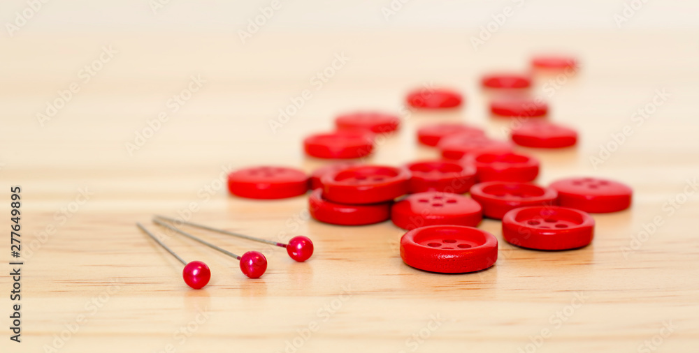 Red sewing supplies - web banner of buttons and pins, DIY concept Red sewing supplies - web banner of buttons and pins, DIY concept