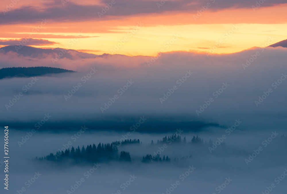 Sunrise in foggy mountains
