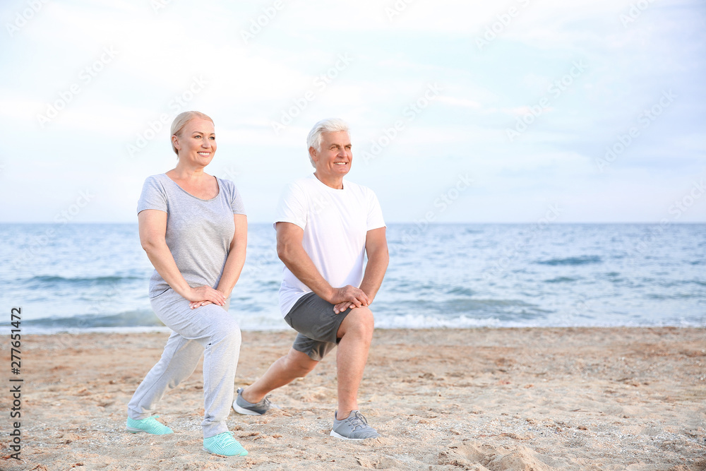 Sporty mature couple training at sea resort Sporty mature couple training at sea resort
