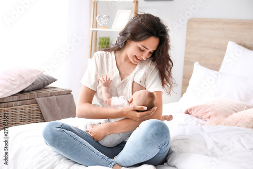 Young woman breastfeeding h...