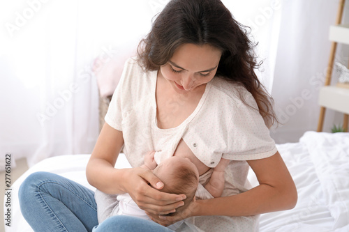 Young woman breastfeeding h...