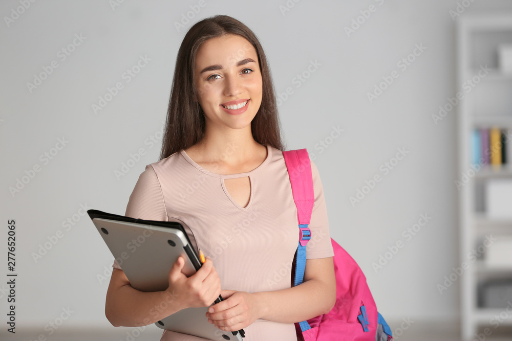 Young female student with laptop at home Young female student with laptop at home