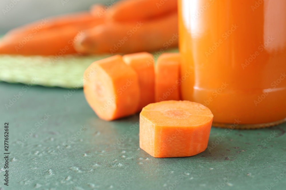 Bottle of tasty carrot juice on table, closeup Bottle of tasty carrot juice on table, closeup