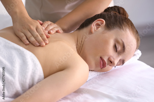 Young woman having massage in spa salon