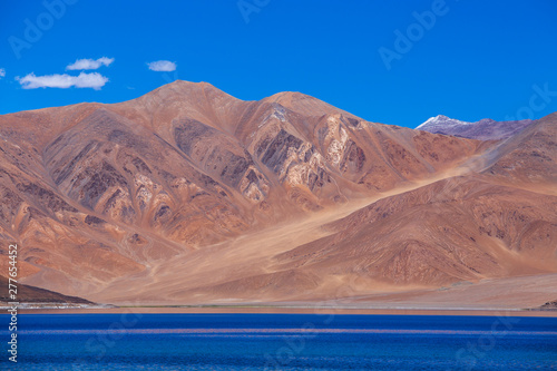 View of majestic rocky mountains against the blue sky and lake Pangong in Indian Himalayas, Ladakh region, India. Nature and travel concept